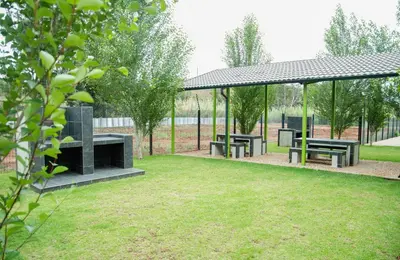 a picnic shelter with benches in a park at 3 Lux Suites in Middelburg