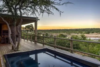 a house with a plunge pool on a wooden deck at Mjejane Bush Camp by Dream Resorts in Hectorspruit