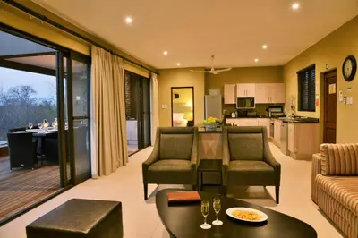 a living room with a couch and a table at Mjejane Bush Camp by Dream Resorts in Hectorspruit