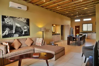 a living room with a couch and a table at Mjejane Bush Camp by Dream Resorts in Hectorspruit