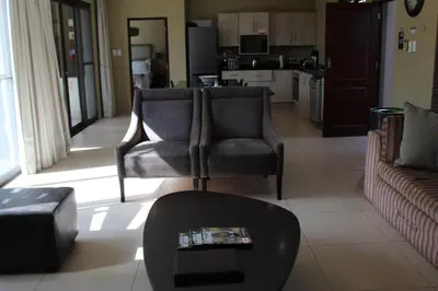 a living room with two chairs and a couch at Mjejane Bush Camp by Dream Resorts in Hectorspruit