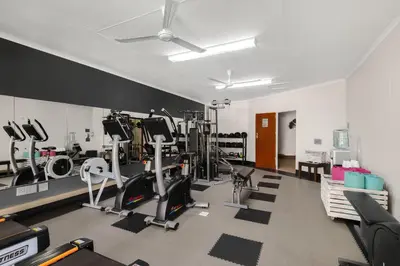 a gym with treadmills and machines in a room at Park Hotel Mokopane in Mokopane