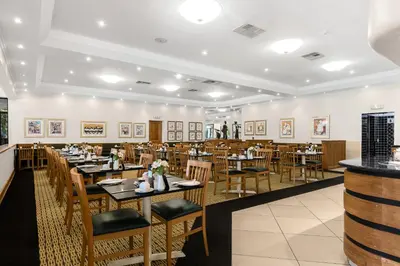 a dining room with wooden tables and chairs at Park Hotel Mokopane in Mokopane