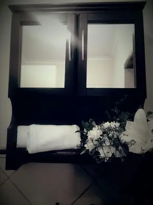 a black and white photo of a bathroom with towels at Shalamanzi Lodge in Hartbeespoort