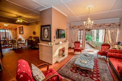 a living room with a couch and a fireplace at Lavender House in White River