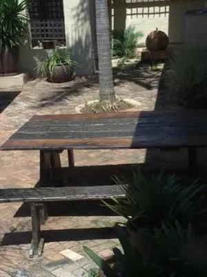a wooden bench sitting in front of a building at Villa Xanelle Boutique Guest House in Centurion