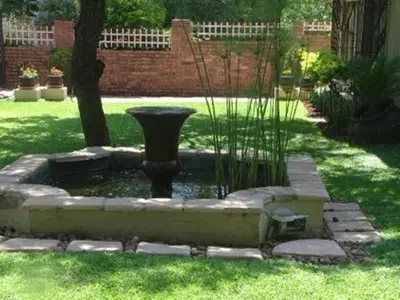 a small pond with a vase in a yard at Villa Xanelle Boutique Guest House in Centurion
