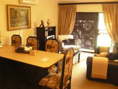 a living room with a table and chairs at Villa Xanelle Boutique Guest House in Centurion