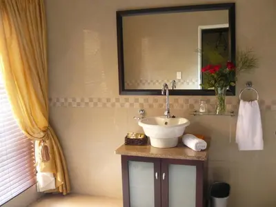 a bathroom with a sink and a mirror at Villa Xanelle Boutique Guest House in Centurion