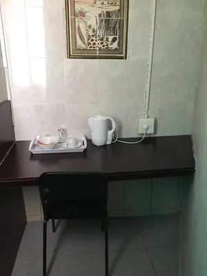 a black desk with a cup and a plate on it at Tropical Paradise Guest House in Nelspruit