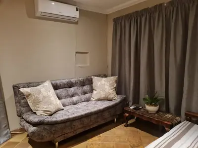 a living room with a couch and a table at 282 Guesthouse/Self-Catering in Centurion