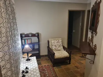 a living room with a chair and a lamp at 282 Guesthouse/Self-Catering in Centurion