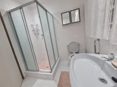 a bathroom with a shower and a tub and a toilet at 282 Guesthouse/Self-Catering in Centurion