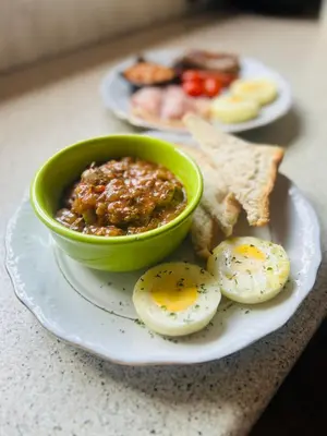 a plate of food with eggs and toast on a table at Wild Dog Guest Lodge in Hoedspruit