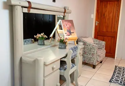 a dressing table with a mirror in a room at Four Seasons Guesthouses in Lephalale