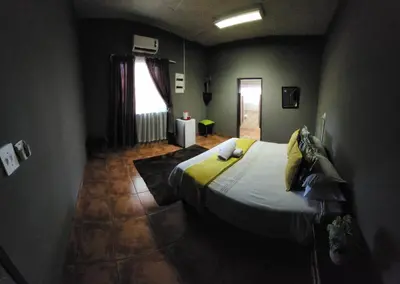 a bedroom with a large bed in a room at Casa Feliz in Mokopane