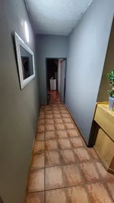 a hallway with a tile floor in a room at Casa Feliz in Mokopane