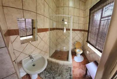 a bathroom with a shower and a sink at Casa Feliz in Mokopane