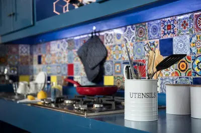 a kitchen counter with utensils in a pot on a stove at Bluemere Living in White River
