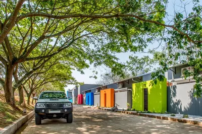 a car parked in front of a row of brightly colored buildings at Bluemere Living in White River