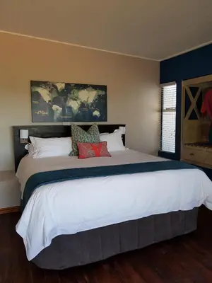 a bedroom with a large white bed with pillows at Bluemere Living in White River