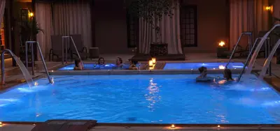 a group of people in a swimming pool at night at Sondela Nature Reserve & Spa Country House in Bela-Bela