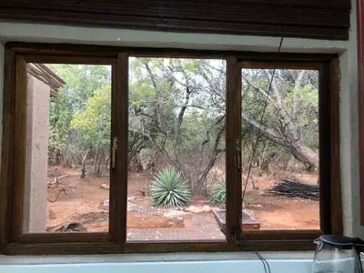 a window with a view of a yard at Mabalingwe Elephant Lodge in Bela-Bela