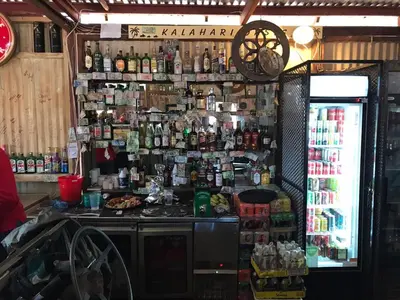 a bar with a lot of bottles on the wall at Mabalingwe Elephant Lodge in Bela-Bela