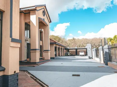 an empty street next to a building with a fence at Khutso Boutique Hotel in Hazyview