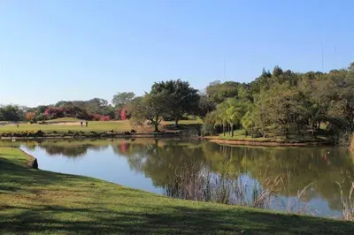 a pond in a park with trees in the background at Kruger Park Lodge 401 in Hazyview