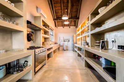 a large kitchen with stainless steel counters and shelves at Kruger Sunset Lodge in Hectorspruit