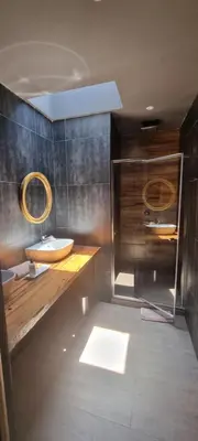 a bathroom with a sink and a mirror at The Highlander Hotel Dullstroom in Dullstroom