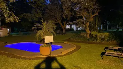 a small pool with a sign in front of it at Safari Club Guest Lodge OR Tambo International Airport in Kempton Park