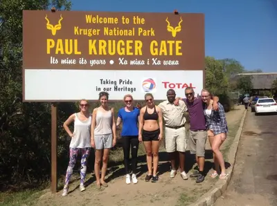 a group of people standing in front of a sign at BTV Guesthouse in Hazyview