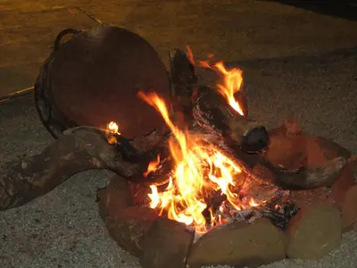 a fire is burning in the street at night at BTV Guesthouse in Hazyview