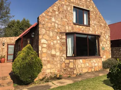 a stone house with a window on the side of it at Marigold's 37 Critchley Common in Dullstroom