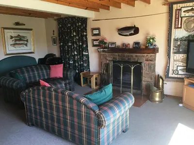 a living room with two couches and a fireplace at Marigold's 37 Critchley Common in Dullstroom