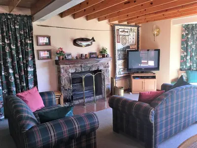 a living room with two couches and a fireplace at Marigold's 37 Critchley Common in Dullstroom