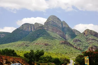 a view of a mountain range with a car at Viewpoint Lodge & Safari Tours in Hazyview