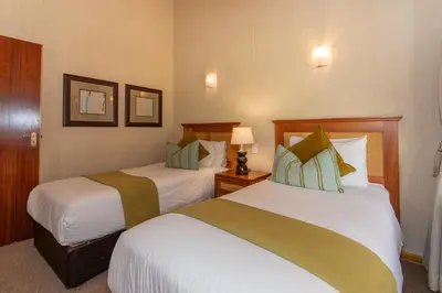 a hotel room with two beds and two lamps at Kruger Park Lodge Unit No 252 with private pool in Hazyview