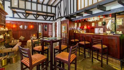a bar with chairs and tables in a restaurant at Kilmorna Manor Guest House in Schoemanskloof