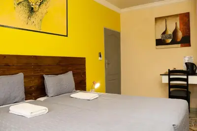 a bedroom with a bed with two towels on it at Mamli Guestlodge & Conferencing in Schoemansdal
