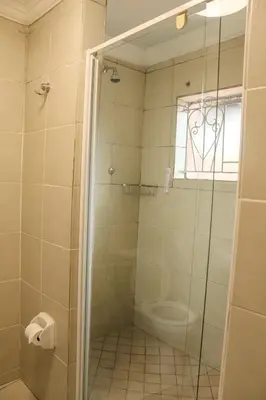 a bathroom with a shower with a toilet and a window at Mamli Guestlodge & Conferencing in Schoemansdal