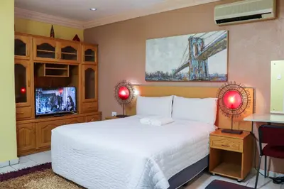a bedroom with a large white bed and a bridge at Mamli Guestlodge & Conferencing in Schoemansdal