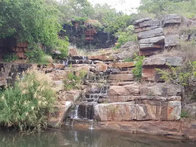 a waterfall on the side of a river at Blyde Canyon, A Forever Resort in Matibidi
