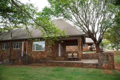 a stone house with two chairs on a porch at Blyde Canyon, A Forever Resort in Matibidi