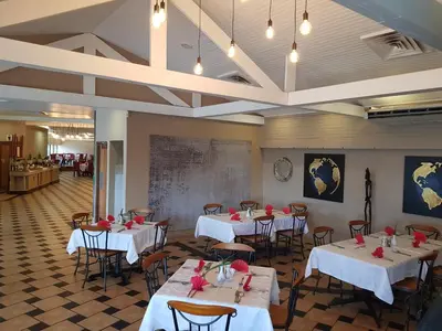 a restaurant with tables and chairs with red roses on them at Blyde Canyon, A Forever Resort in Matibidi