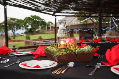 a table with a black table cloth with plates and a vase at Blyde Canyon, A Forever Resort in Matibidi