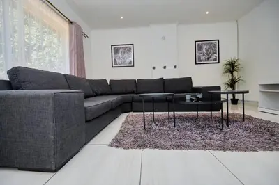 a living room with a couch and a table at Menlyn Maine: The Exquisite Lunette in Pretoria