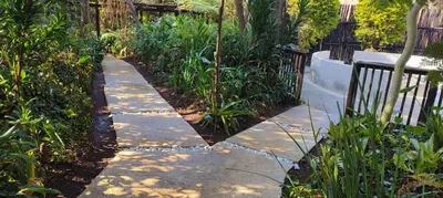 a garden path with plants and a fence at Dar Amane Guest House in Graskop